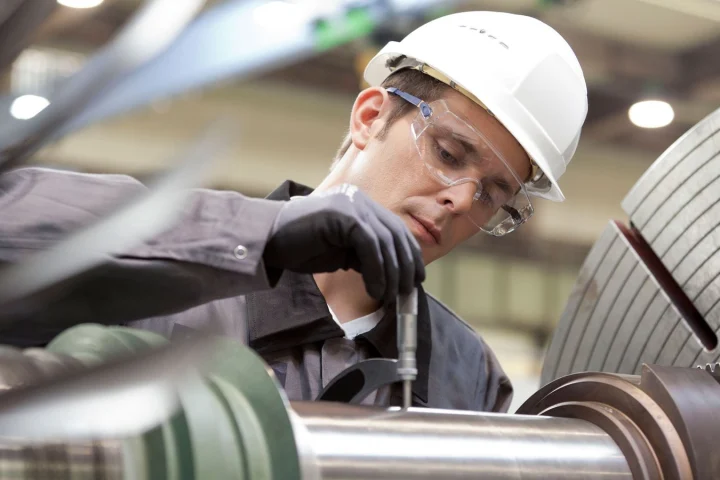 Field technician servicing industrial machinery